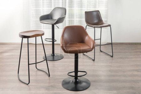 a room featuring a line of modern brown bar stool chairs with metal legs