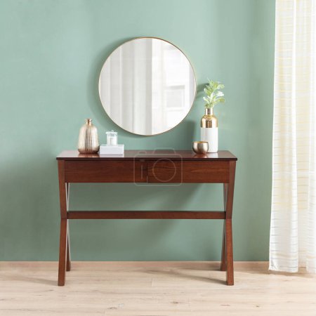 Photo for Round mirror hanging on light green wall, Mid Century Three-Drawer Wood Console Table in the interior of the modern room - Royalty Free Image