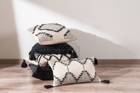 Photo for Cushions of different shapes and colors are lying on the floor, stacked on top of each other - Royalty Free Image