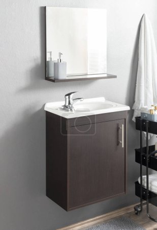 Sophisticated bathroom interior, a minimalist espresso vanity cabinet with an integrated white rectangular basin, sleek chrome faucet, coordinated matte soap dispensers, and a white textured towel.