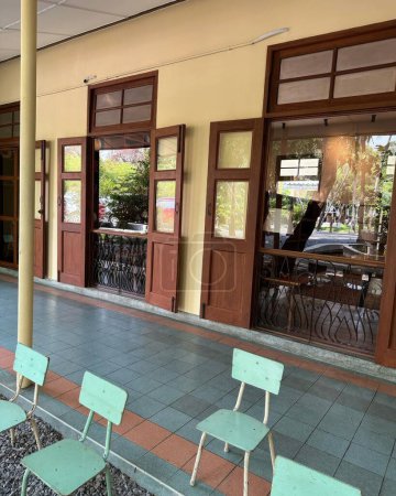 Interior of a cafe with tables and chairs on the terrace