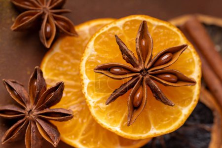 Photo for Top view, in the foreground, a star of star anise laid on orange slices - Royalty Free Image