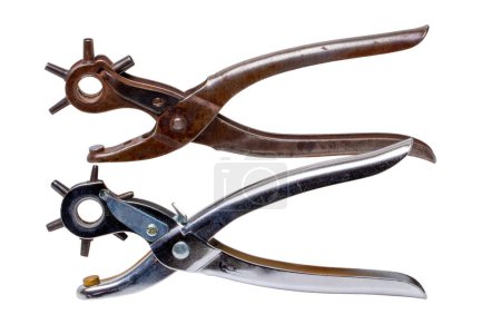 Photo for Tailor accessories. Close-up of a antique adjustable steel punch pliers and a modern hole punch tool isolated. Clipping path. Tools from tailor, saddler or cobbler. - Royalty Free Image