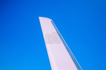 View at the part of a wing of the airplane or airliner during the flight from the window with blue sky and without clouds.Wing of aircraft. Copy space.