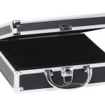 Closeup of a opened empty small black silver equipment case or suitcase with a latch isolated on a white background.