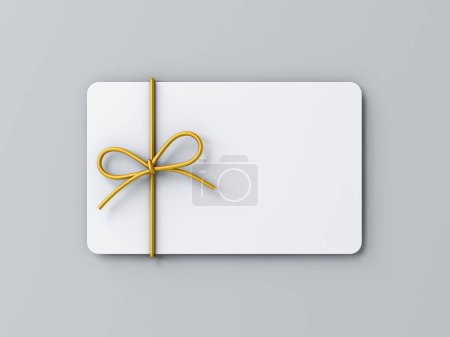 Téléchargez les photos : Carte-cadeau blanche minimale vierge ou chèque-cadeau avec noeud de corde de ruban doré isolé sur fond gris avec ombre concept d'idée créative minimale rendu 3D - en image libre de droit