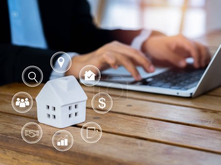 Photo for Property value, home investment, real estate online market and house selection concepts. Property valuation diagram with icons virtual near white miniature house with business people using laptop. - Royalty Free Image