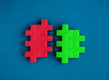 Photo for Red and green puzzle blocks between arrows are joining each other on blue background, minimal style. Business partnership, teamwork, collaboration, and contrast opposite colors concepts. - Royalty Free Image