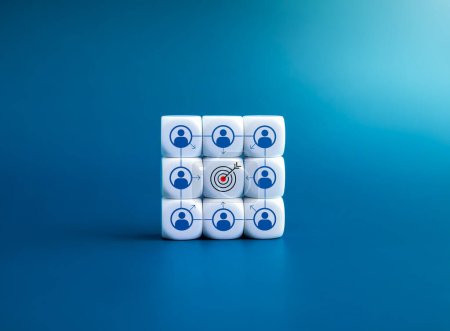 Photo for Same target, teamwork, organization, colleague, team collaboration concepts. Goal symbol at the center of person icon with objective arrows on white dice blocks stack isolated on blue background. - Royalty Free Image