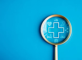 Healthcare service, hospital website online search, wellness plan and insurance concept. Health, care and medical element icon symbols in magnifying glass lens on blue background with copy space. mug #679884878