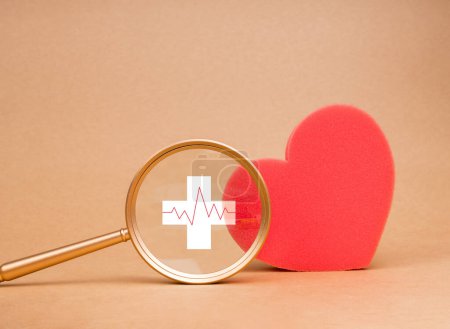 Photo for Heart medical check up, healthcare concept. Red pulse beat measure icon on the white cross in magnifying glass lens in front of big red heart isolated on plain background, minimal. Healthy lifestyle. - Royalty Free Image