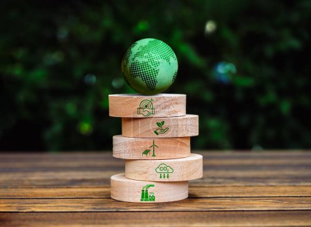 Green life sustainability, environment responsibility concept. 3d Green earth globe on top of round wood block stack with cooperation, carbon reduction and renewable energy icon, on leaves background.
