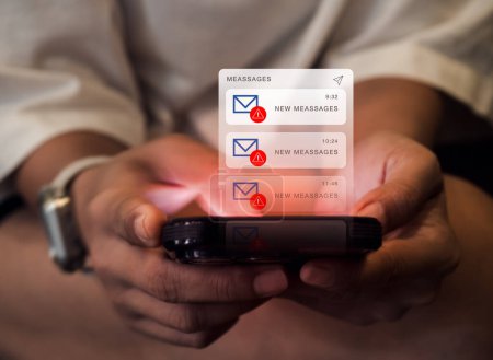 SMS spam and fake text message phishing concept. System hacked warning alert, email hack, scam malware spreading virus on messages alert virtual on mobile smart phone screen in hands, dark tone.