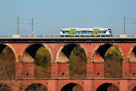 Photo for Netzschkau, Germany - April 30, 2023: Vogtland regional train crosses the Goltzsch Viaduct, the largest brick-built railway bridge in the world in Saxony, Germany - Royalty Free Image