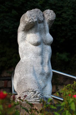 Chemnitz, Germany - June 12, 2023: Female nude torso, a stone sculpture by Harald Stephan, 1982. Located in Schlossbergpark, Chemnitz.