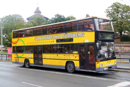 Photo for Nuremberg, Germany - August 27, 2023: Hop-On Hop-Off sightseeing bus in the city center. Tours on yellow double deckers are popular among tourists visiting the main landmarks and attractions of the city. - Royalty Free Image