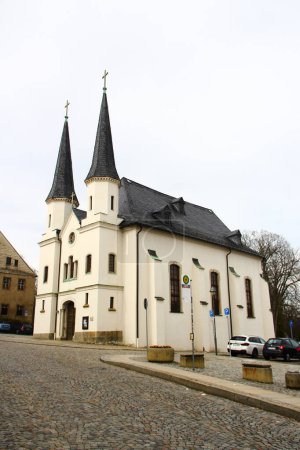 Foto de Schneeberg, Alemania - 26 de marzo de 2024: Vista de la Iglesia Hospitalaria de Santa Trinidad en Schneeberg, una histórica ciudad minera en las montañas Minerales, Sajonia, Alemania - Imagen libre de derechos