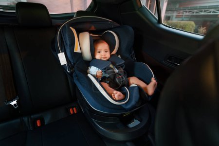 Photo for Happy newborn baby sitting in an infant car seat, safety chair travelling - Royalty Free Image