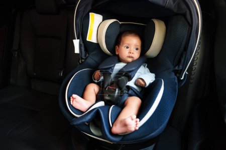 Photo for Newborn baby sitting in an infant car seat, safety chair travelling - Royalty Free Image