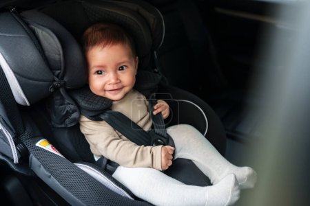 Photo for Happy baby sitting in the infant car seat, safety chair travelling - Royalty Free Image
