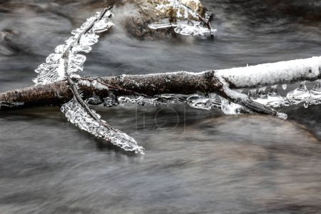 frosts on stones, surrounding a stream or river, winter atmosphere, cold winter mornings, very cold weather