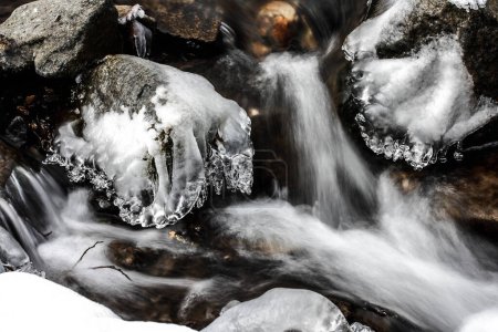 frosts on stones, surrounding a stream or river, winter atmosphere, cold winter mornings, very cold weather