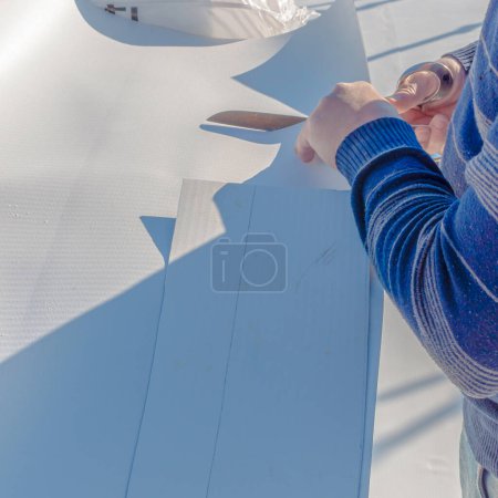Photo for Worker specialized in mounting PVC membranes, TPO in the process of installing a water resistant system - Royalty Free Image