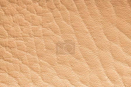 Photo for Beige artificial or synthetic leather background with neat texture and copy space, colorful fabric sample with leather-like finish aimed for upholstery, fashion, sewing or footwear projects - Royalty Free Image
