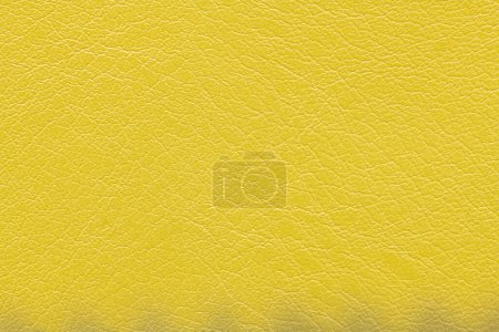 Photo for Yellow artificial or synthetic leather background with neat texture and copy space, colorful fabric sample with leather-like finish aimed for upholstery, fashion, sewing or footwear projects - Royalty Free Image