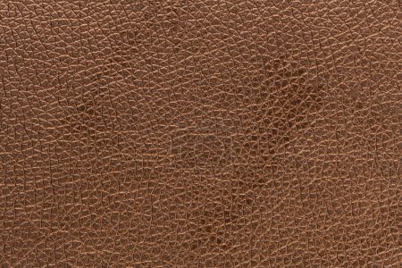 Photo for Brown bronze artificial or synthetic leather background with neat texture and copy space, colorful fabric sample with leather-like finish aimed for upholstery, fashion, sewing or footwear projects - Royalty Free Image