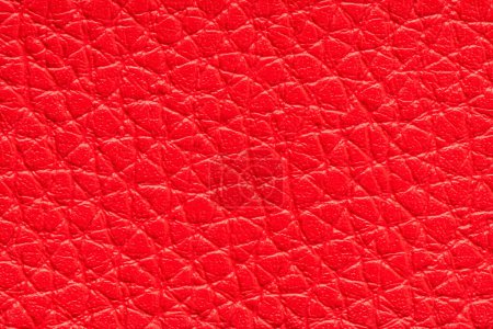 Photo for Red artificial or synthetic leather background with neat texture and copy space, colorful fabric sample with leather-like finish aimed for upholstery, fashion, sewing or footwear projects - Royalty Free Image