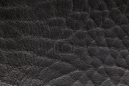 Photo for Black artificial or synthetic leather background with neat texture and copy space, colorful fabric sample with leather-like finish aimed for upholstery, fashion, sewing or footwear projects - Royalty Free Image