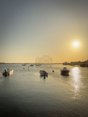 Photo for Some fishing boats moored at the pier in Sao Jacinto at sunset in Aveiro, Portugal - Royalty Free Image