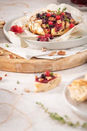 Baked camembert cheese served with the addition of red fruits jam