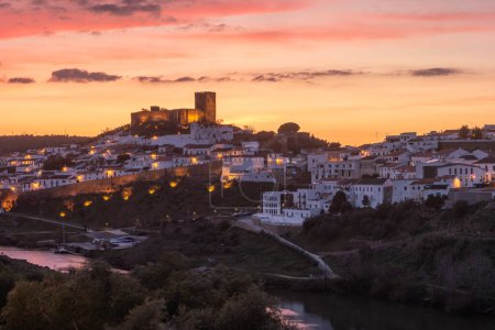 Sunset landscape in Mertola. Medieval city called Mertola in Alentejo region in south Portugal. Medieval castal on top of the hill in center of city.