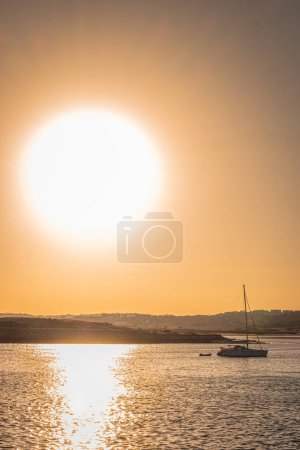 Photo for Harbor from Alvor with a boat at sunset in Algarve, south Portugal. - Royalty Free Image