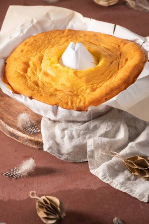 Pao de Lo de Alfeizerao. The traditional Portuguese sponge cake wrapped in the typical paper used on the baking on kitchen countertop decorated with paper eggs, feathers and willow branches. Copy space