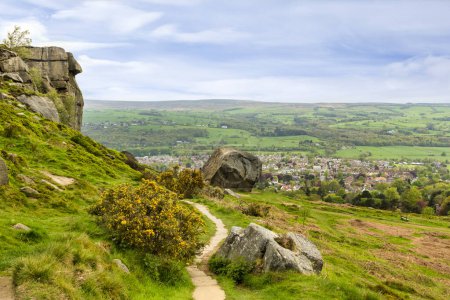 Photo for Ilkley Moor, with the Cow and Calf rocks, a footpath, gorse, and a view over the West Yorkshire mill town of Ilkley. - Royalty Free Image