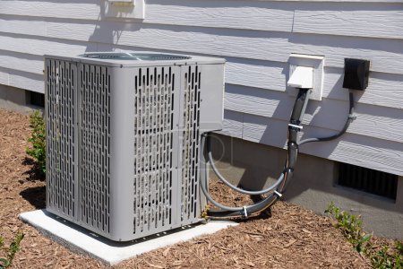 Photo for Air Conditioner unit attached to residential property - Royalty Free Image