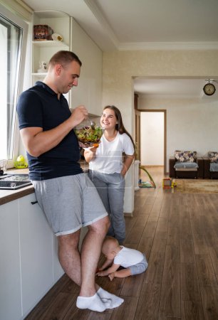 A married couple in a modern kitchen, standing and communicating. Relationship concept, love, home, breakfast. High quality photo