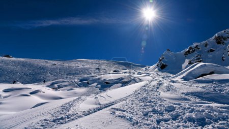 Photo for Amazing sunny day at the Meribel ski resort in France. Skiers exploring off piste areas with fresh snow. - Royalty Free Image