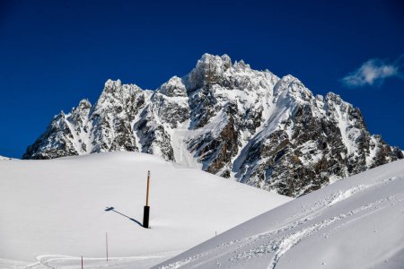 Photo for Ski tracks on the fresh snow at the off piste area at the Meribel Ski Resort in France. Beautiful view to the mountains on the background. - Royalty Free Image