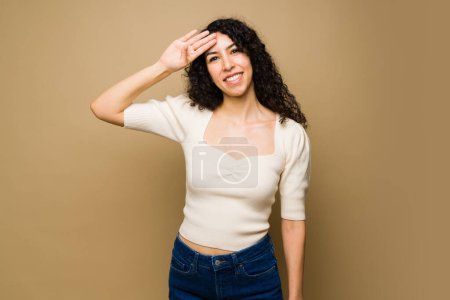 Photo for Cheerful gorgeous woman smiling using sign language and saying hello looking very happy - Royalty Free Image