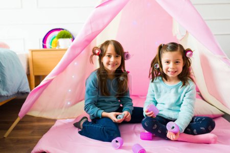 Photo for Portrait of beautiful caucasian children having a fun playdate playing together doing different hairstyles - Royalty Free Image