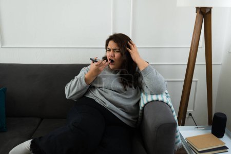Photo for Angry overweight woman screaming looking upset while talking on the phone and fighting having problems - Royalty Free Image