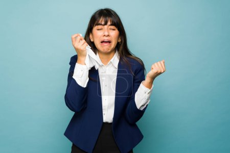 Téléchargez les photos : Sad upset businesswoman crying and using tissue while feeling depressed about work problems - en image libre de droit