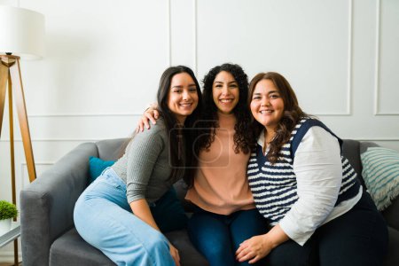 Photo for Portrait of happy beautiful women best friends smiling and making eye contact while having a fun leisure time together at home - Royalty Free Image