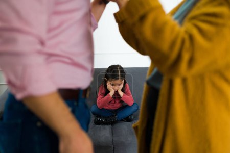 Photo for Depressed sad child feeling in the middle of her parents fight about child custody after divorce - Royalty Free Image