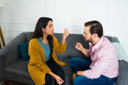 Photo for Sad upset couple arguing at home and having marriage problems thinking about divorce - Royalty Free Image