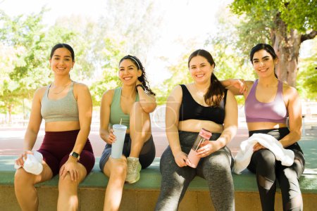 Photo for Portrait of happy group of women with body diversity in activewear making eye contact ready to exercise and embrace body positivity - Royalty Free Image
